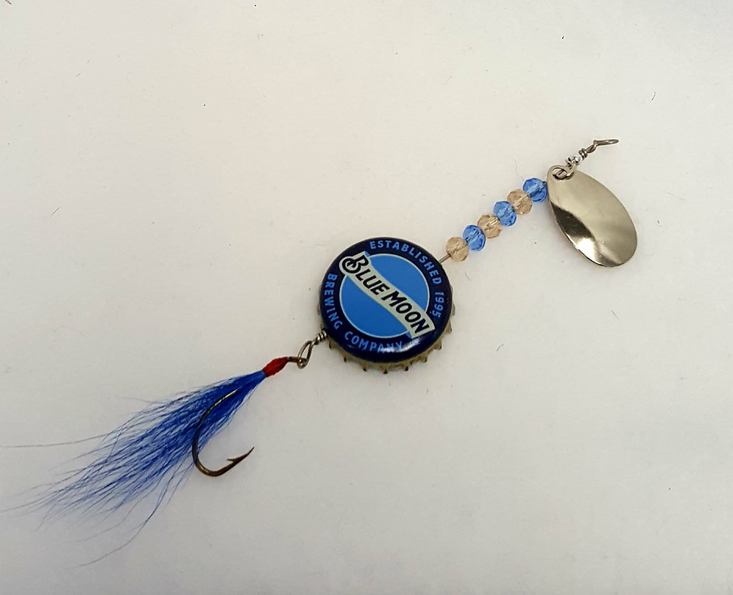 Lure has a blue bottle cap with clear & blue beads, and blue fly.