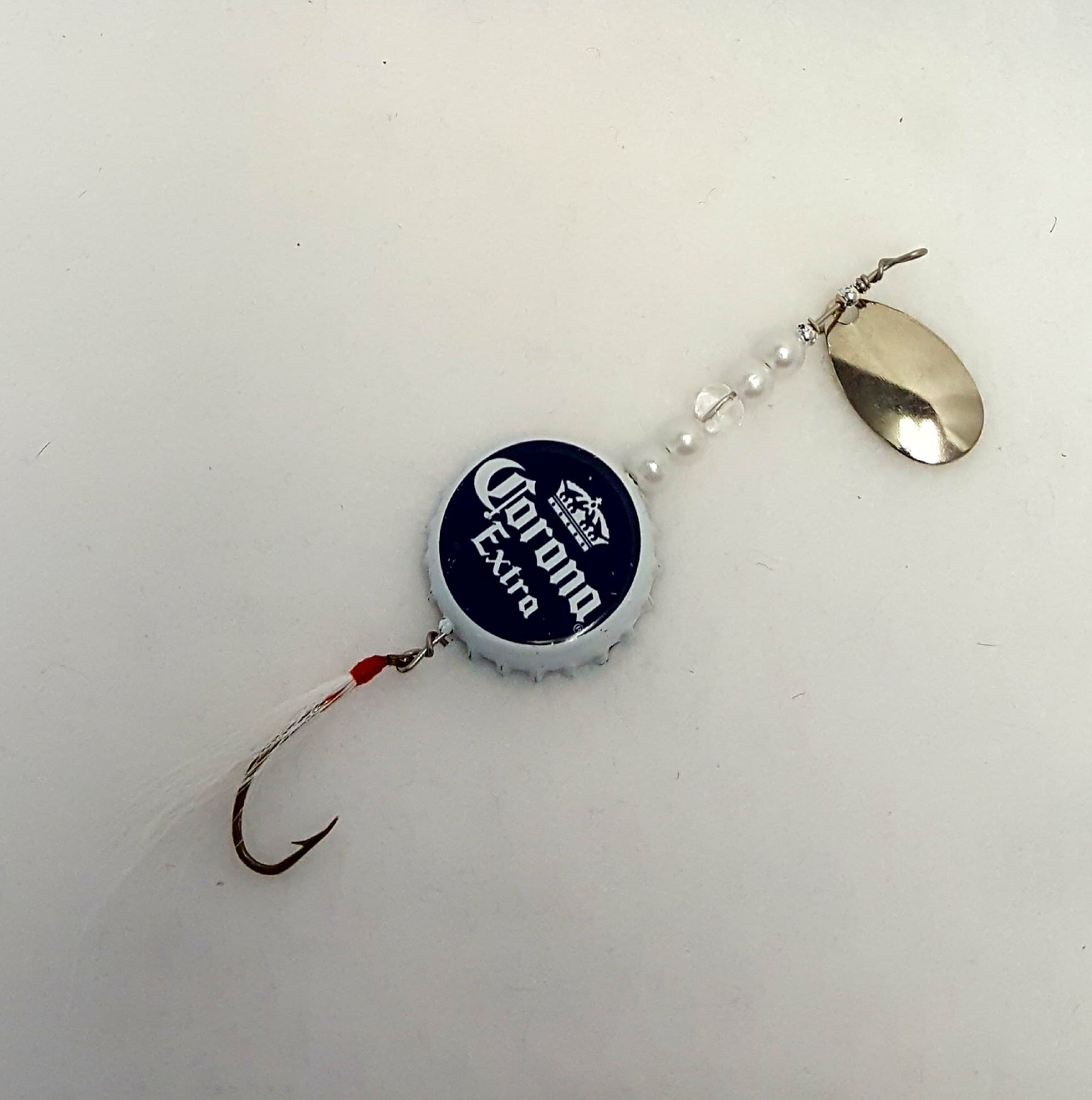 Lure has a white & blue bottle cap with clear & white beads, and white fly.