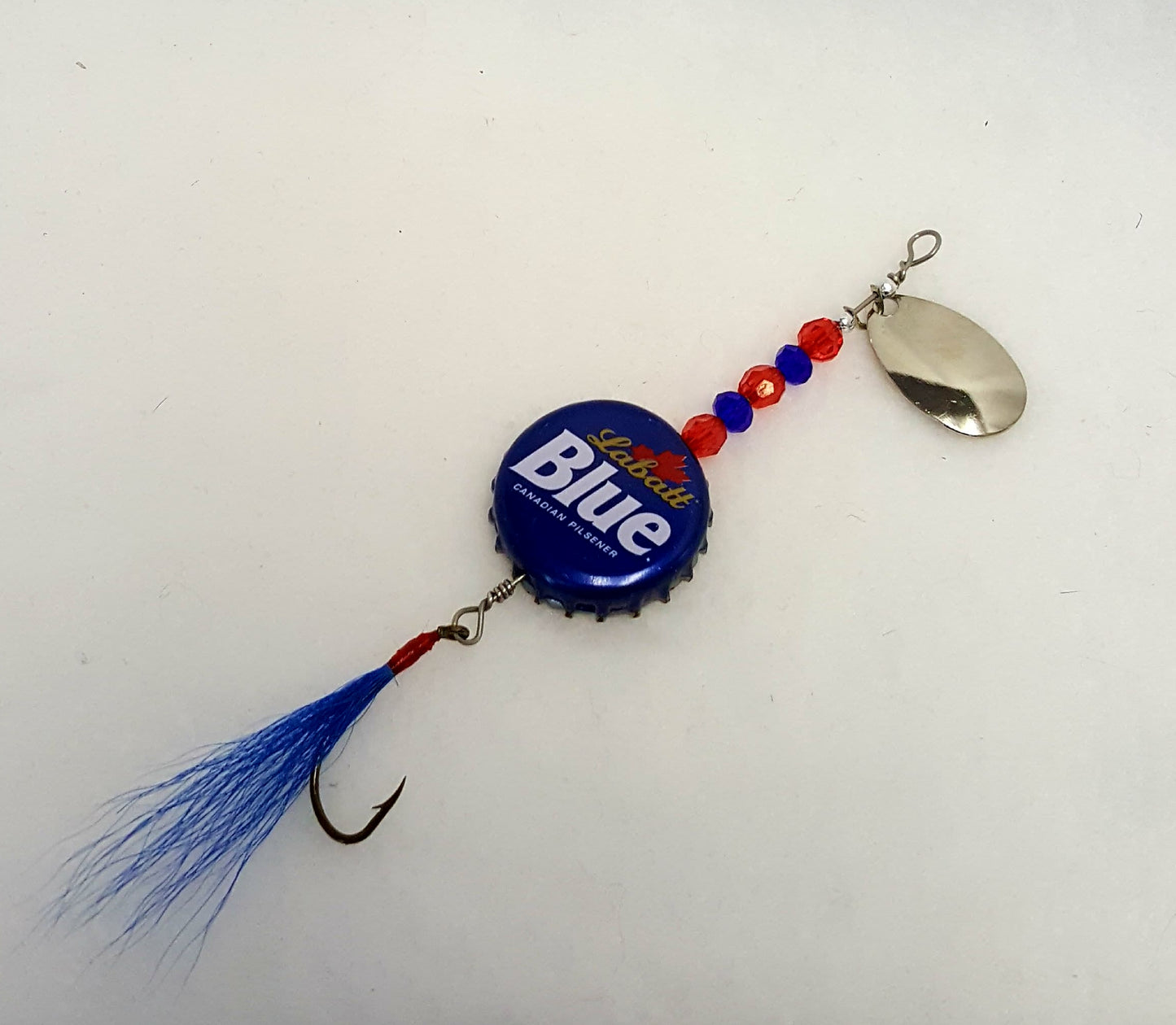 Lure has a blue bottle cap with red & blue beads, and blue fly.