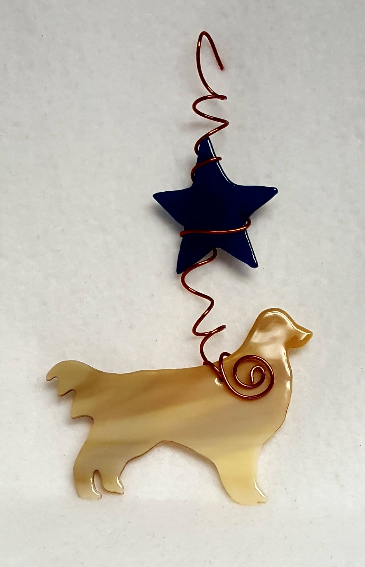 Golden retrievers are known for their happy playful personalities, this one likes to be under a deep blue star. Suncatcher hangs 7 inches.