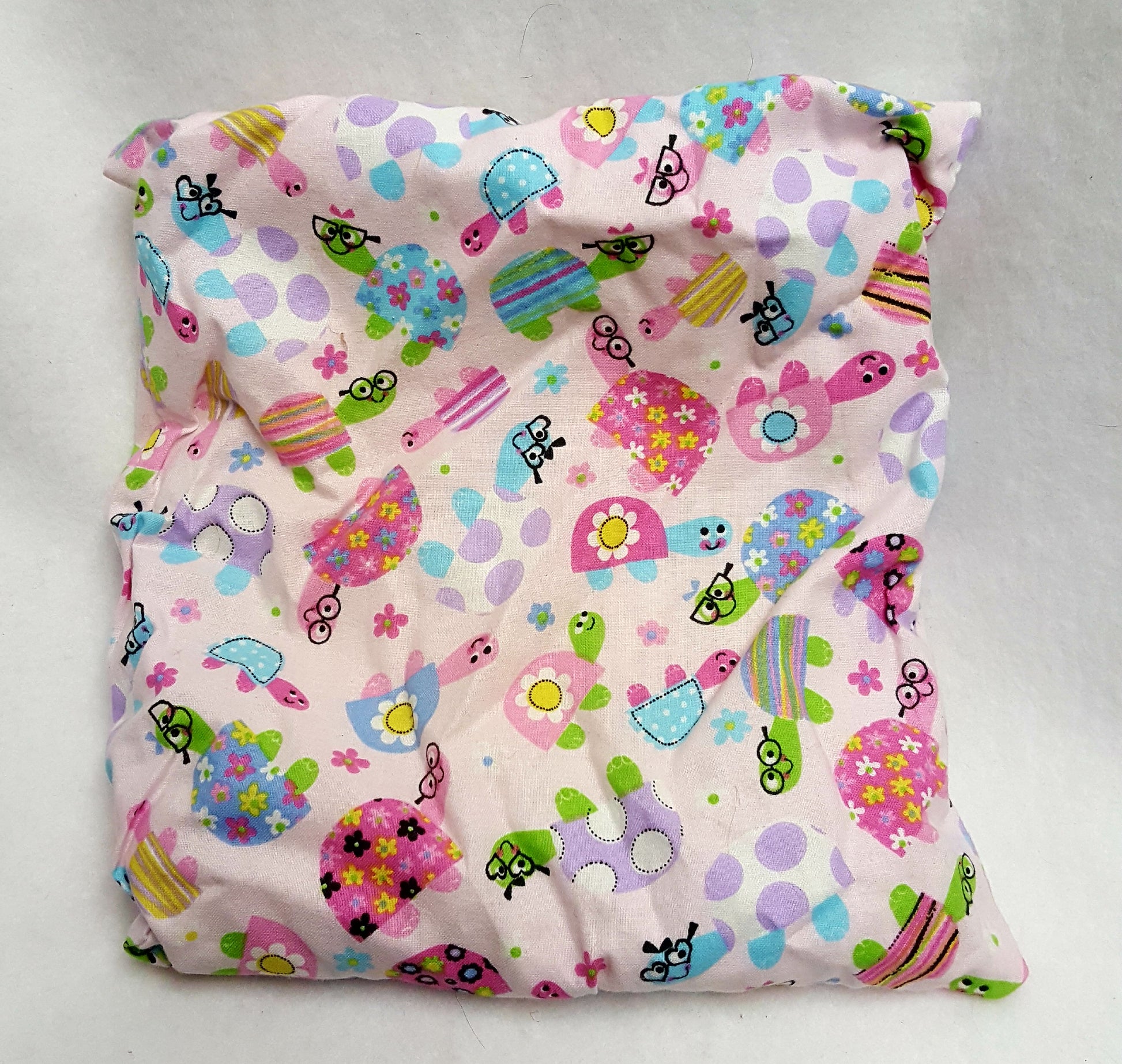 For the young or young at heart - slip cover is pink with colorful cartoon turtles.
